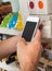 Man\'s Hand With Smart Phone Scanning Product