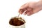 The man\'s hand with spoon takes coffee