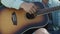 Man`s hand strumming guitar