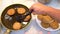 A man`s hand takes ready-made cutlets from the pan with a kitchen spatula.