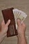 A man`s hand takes Russian banknotes from his wallet. Close Up