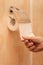 man\'s hand tears off a piece of toilet paper in the toilet