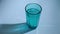 A man`s hand throws a soluble pill into blue glass of water. The tablet fizzes and dissolves. Healthycare and medicine concept