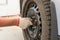 Man\'s hand tightening the screws on the wheel