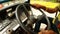 Man\'s hand turns steering wheel of moving autorickshaw on road of Rishikesh