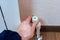 A man`s hand twists the tap on the heating battery. Adjustment of heat supply to the apartment, room.