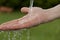 Man\'s hand under running water