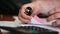 A man`s hand uses a sticker and fastens documents with a stapler.