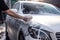 A man\\\'s hand washes a white car with foam. Generative ai