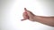 A man\'s hand on a white background shows the gesture of greeting surfers shaka