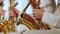 A man`s hand in a white suit in a jazz band on a gold saxophone. Close-up.