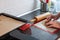 A man`s hands carve heart-shaped biscuits out of rolled dough