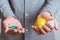 Man`s hands close-up holding pills in one hand and lemon with garlic in other. T