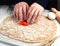 Man`s hands cutting hearts from the dough at home in the kitchen. Homemade pastry. Cooking process. Hobby. Close-up