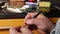 Man`s hands fix microswitch of electrical card using tweezers.