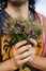 Man\'s hands holding bouquet of fresh heather flowers