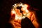 Man`s hands holding festive garland with burning lights in darkness.