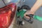 Man`s hands holding gas pump and filling the car with fuel close-up. Energy industry. Gas station business/market
