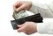Man\'s hands holding leather wallet with dollars