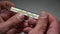 Man`s hands holding thermometer to measure body temperature, closeup
