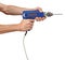 Man\'s hands holds a blue drill