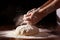 Man\\\'s hands knead the dough for baking bread. The chef