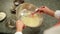 Man's hands mixing liquid batter for crepes or cake