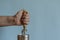 Man`s hands open a tin can with an old can opener with a wooden handle