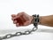 a man\'s hands shackled by chains 2