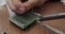 Man`s hands soldering an electronic board.