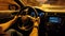 Man\\\'s hands tightly grip the steering wheel while traveling along a highway at dusk. Picture inside the car