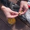 Man`s hands trying put bait on fishing hook