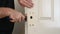 Man`s hands use rusty chisel for door lock hole