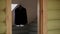 A man`s jacket hangs on a hanger in the room