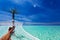 Man\'s legs in hammock over tropical lagoon