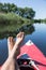 Man\'s legs over canoe.