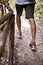 Man`s legs on park or forest footpath with handrail closeup