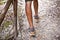 Man`s legs on park or forest footpath with handrail closeup