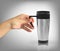 Man`s naturalistic hand holds Realistic 3D model of thermos cup. Vector Illustration
