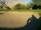 Man\'s Shadow Appears to be Sitting and watching in Golf Course Sand Trap