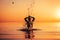 Man`s silhouette in calm water at sunset