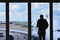 A Man`s Silhouette Facing Window at London Heathrow Airport