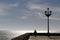 Man`s silhouette walking along seafront to the evening, Cadiz, A