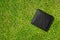 Man`s wallet fell on green grass soccer field