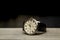 A man's wristwatch lying on a wooden table