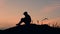 Man in sadness, silhouette of a sad man on the mountain. Silhouette of a depressed man at sunset