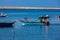 Man sailing in his boat at Douro River mouth in a beautiful early spring day at Porto city