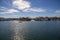 A man sailing a small motor boat at Huntington Harbour with boats and yachts docked in Huntington Harbour and homes