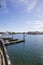 A man sailing a small motor boat at Huntington Harbour with boats and yachts docked in Huntington Harbour and homes