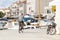 Man in sailor T-shirt riding a bike on the dock promenade in Mediterranean town